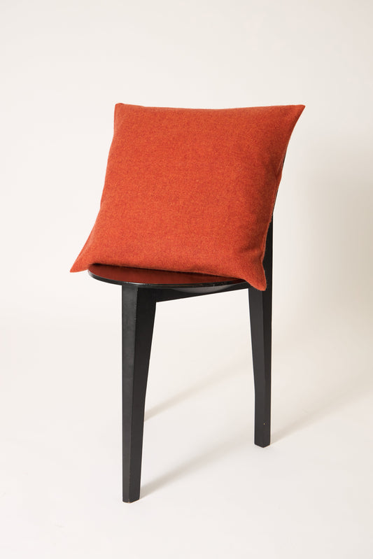 This image displays the Uno Cushion Cover, emphasizing its design and elegance. The cushion cover is showcased on a uniquely designed chair, highlighting its fit and presentation.