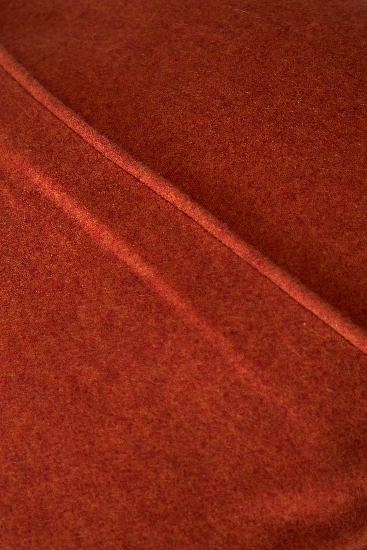 This image displays the Uno Cushion Cover, emphasizing its design and elegance. The cushion cover is showcased on a uniquely designed chair, highlighting its fit and presentation.