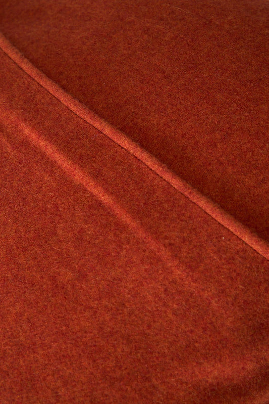 This image displays the Uno Cushion Cover, emphasizing its design and elegance. The cushion cover is showcased on a uniquely designed chair, highlighting its fit and presentation.