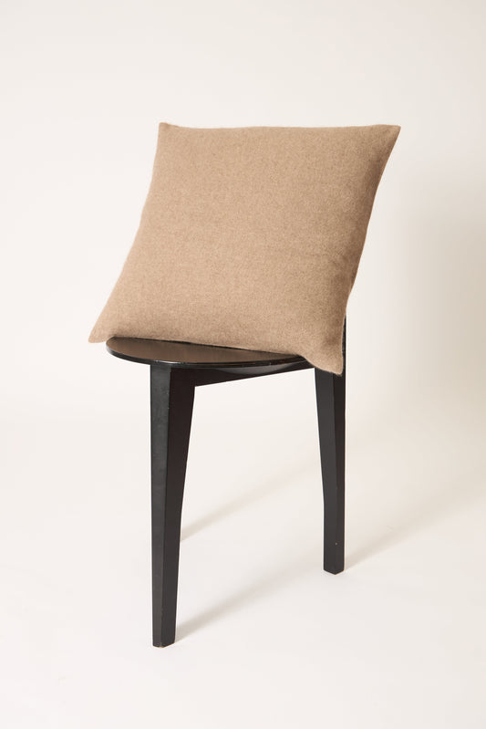 This image displays the Uno Cushion Cover, emphasizing its design and elegance. The cushion cover is showcased on a uniquely designed chair, highlighting its fit and presentation.