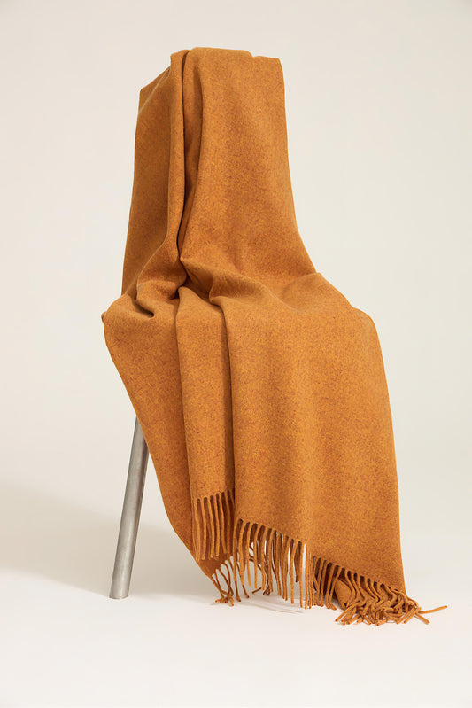 A honey cashmere throw with fringes at the top and bottom edges, displayed on a plain background.