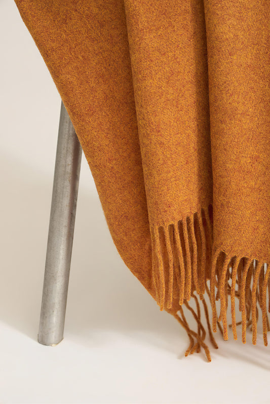 A honey cashmere throw with fringes at the top and bottom edges, displayed on a plain background.