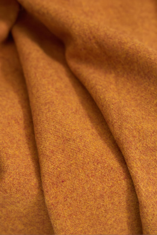 A honey cashmere throw with fringes at the top and bottom edges, displayed on a plain background.