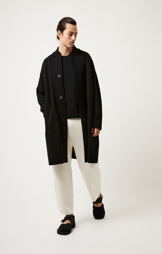 Person wearing Storm relaxed fit cashmere coat in colour Black. 