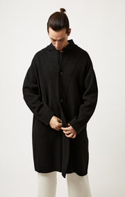 Person wearing Storm relaxed fit cashmere coat in colour Black. 
