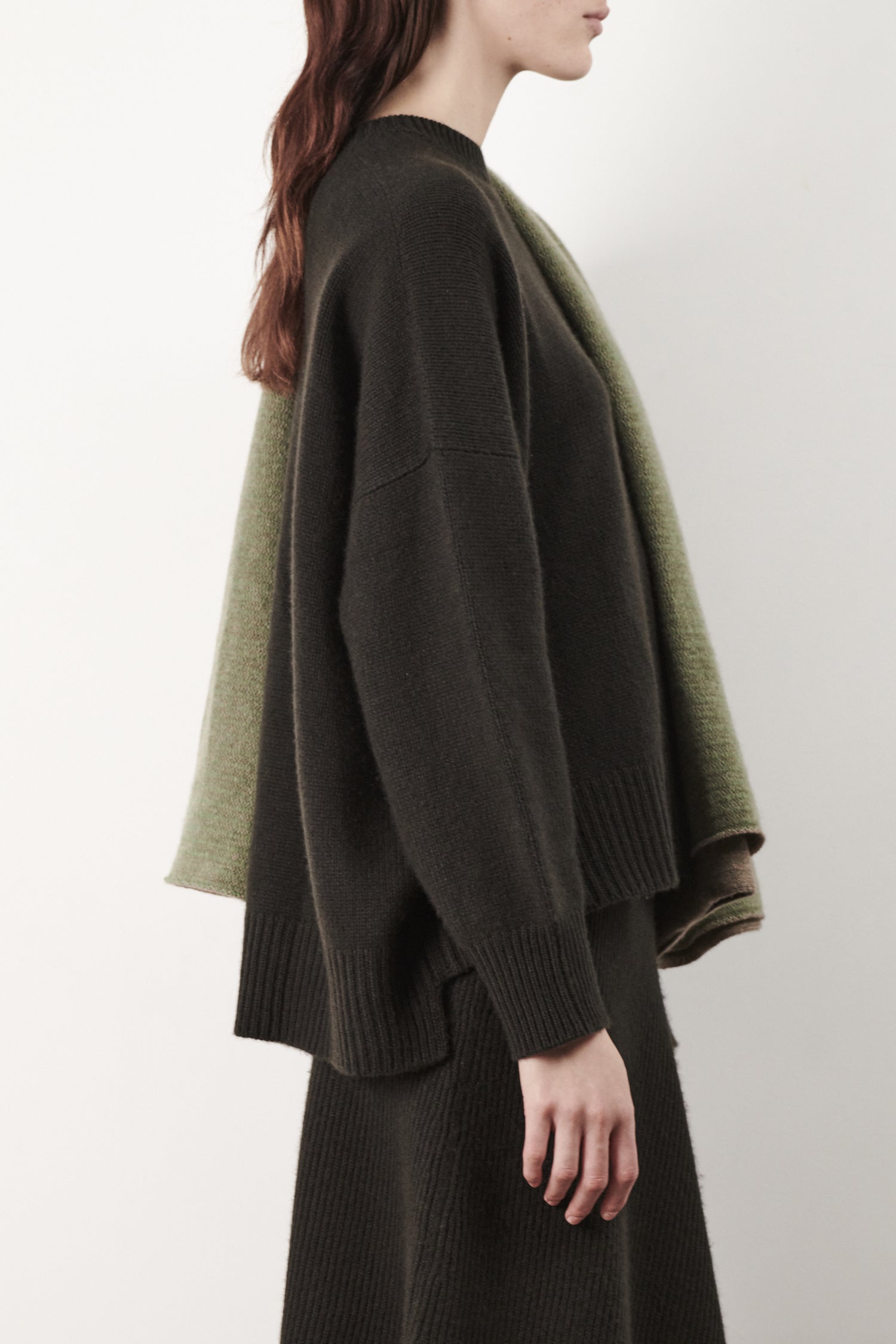 This image features the Aila Sweater, a stylish and versatile garment displayed on a model. The sweater is crafted in a chunky jersey stitch, offering a cozy and comfortable fit.
