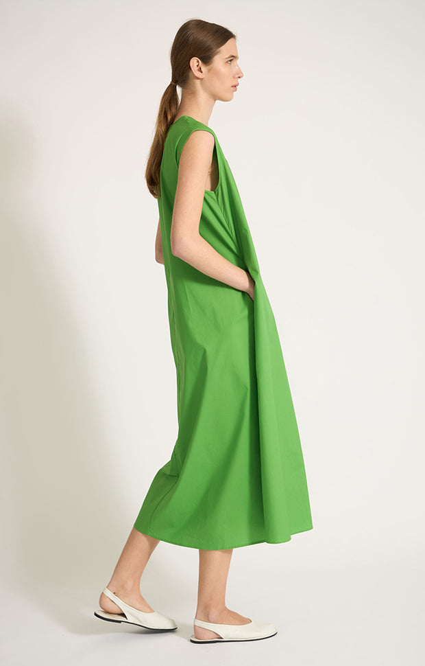 Woman wearing Altai woven a-line v-neck maxi dress made from cotton in colour Green.