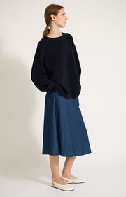 Person wearing Axa oversized fit cashmere sweater with drop shoulders and rounded sleeves in colour Ocean.