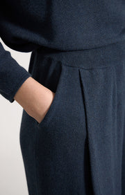 Woman wearing Cara cotton wide leg trousers in colour Indigo. 