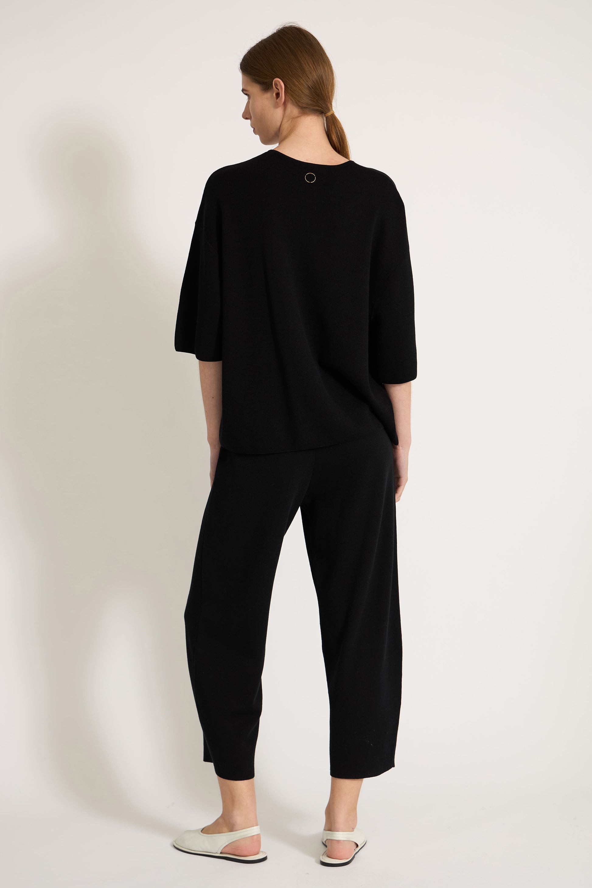 Woman wearing a black top on a white background
