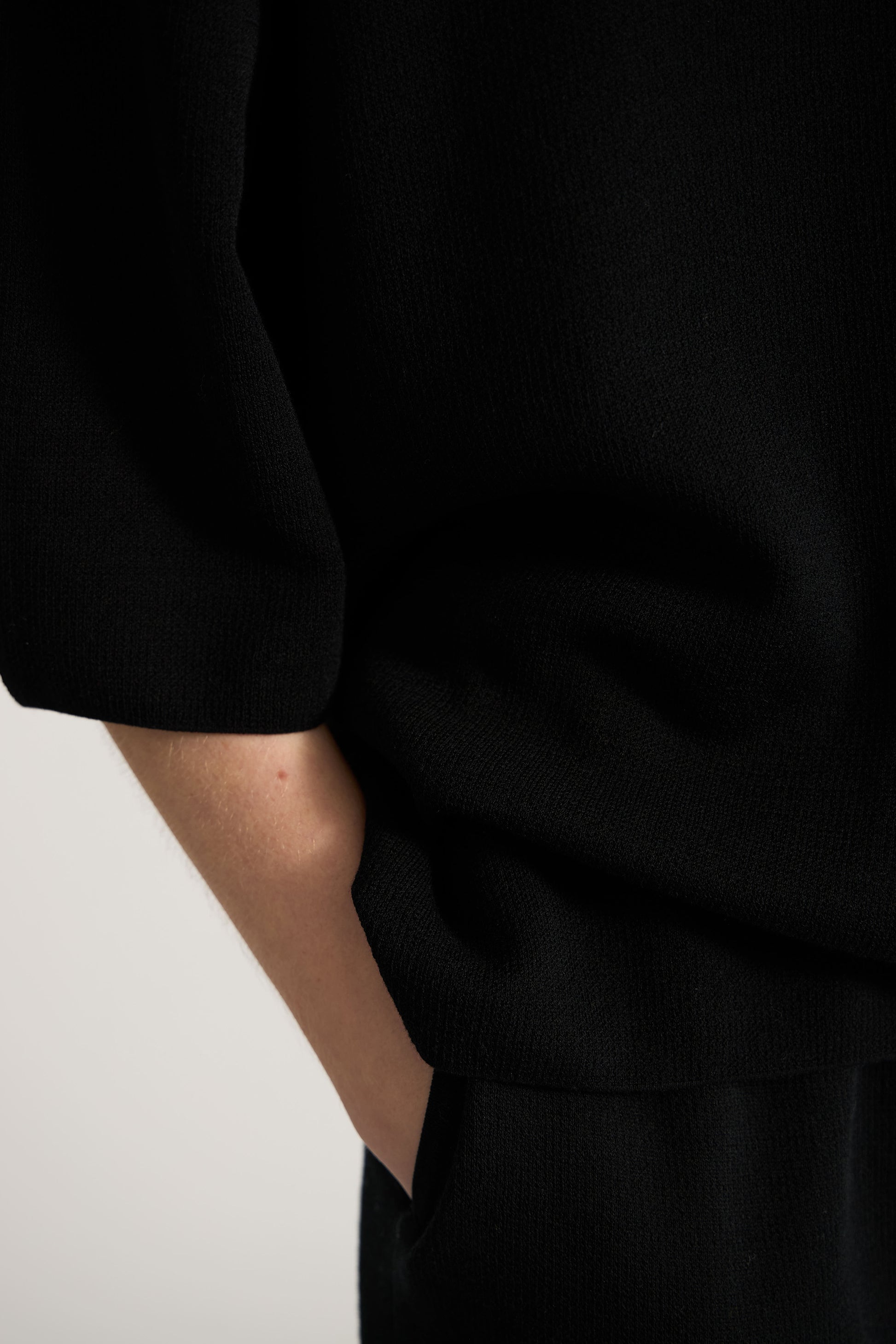 Closeup of a black top sleeve detail