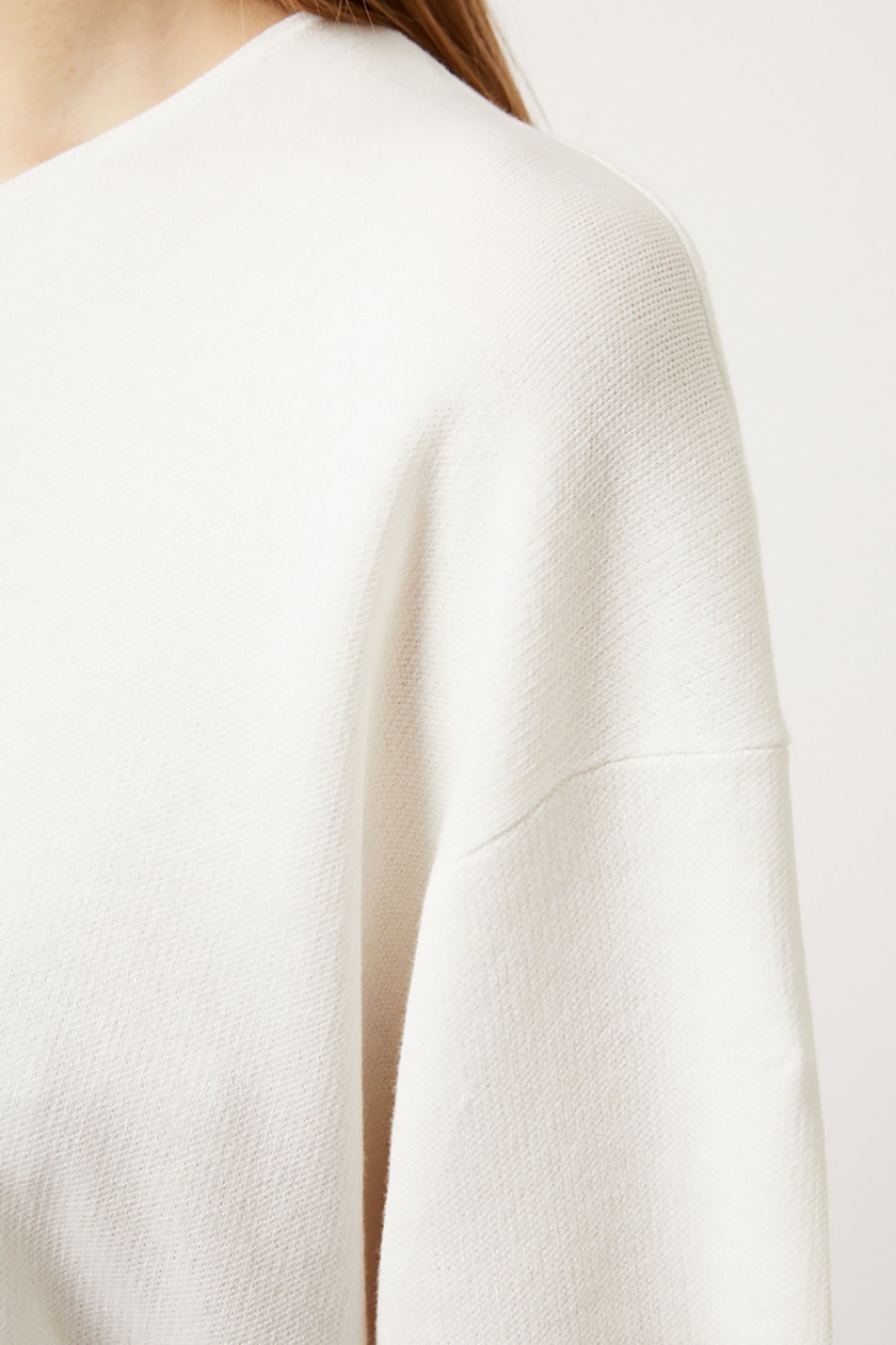 Close-up of an ivory top on a plain background