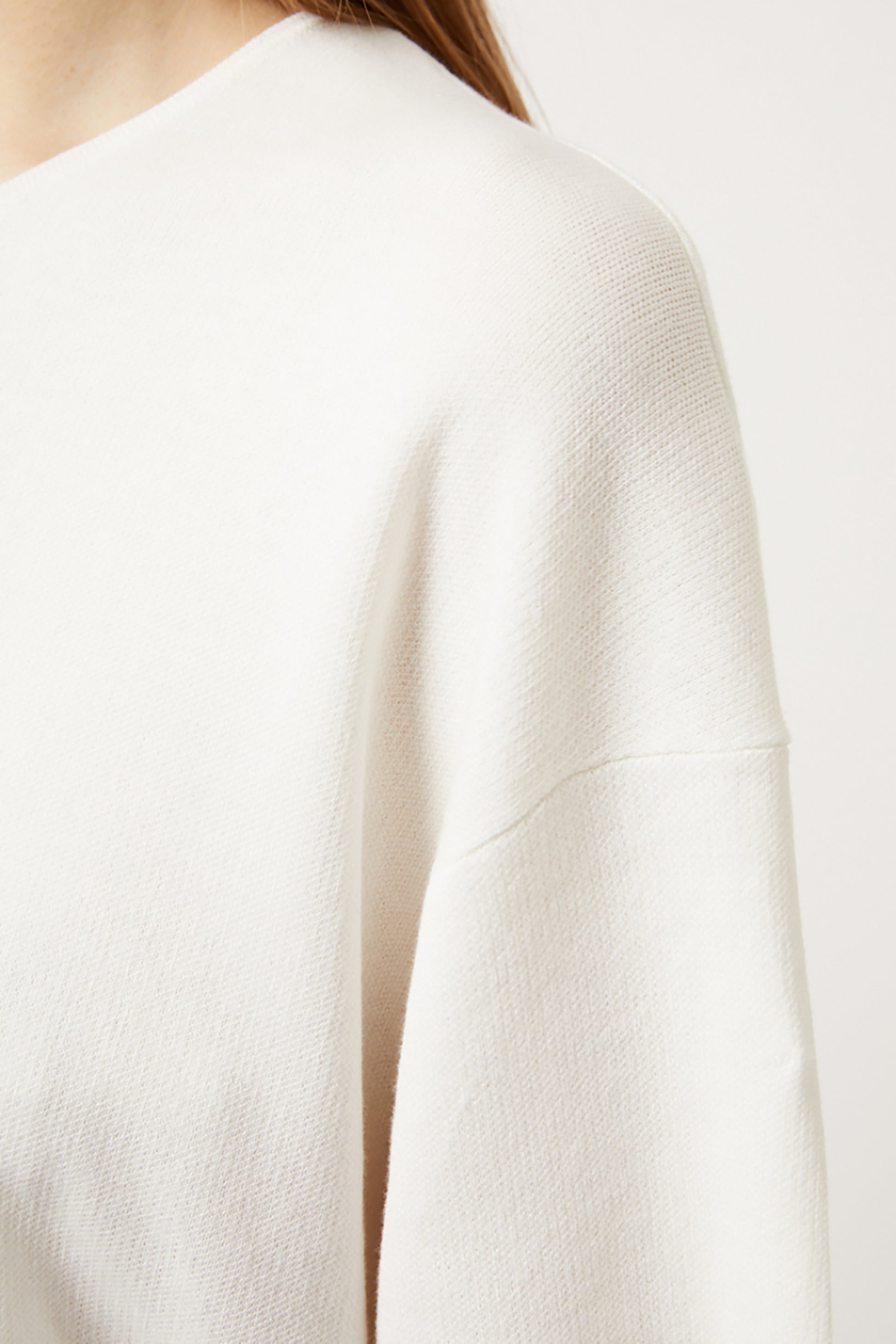 Close-up of an ivory top on a plain background