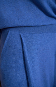 Woman wearing Manti wide leg cashmere trousers with elasticated waistband in colour Azure. 