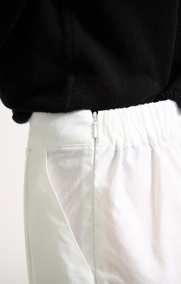 Woman wearing Morci wide-leg cotton trousers in colour White. 