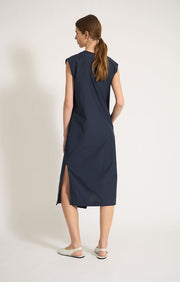 Woman wearing Nevia lightweight V-neck cotton dress with side seam pockets in colour Navy. 
