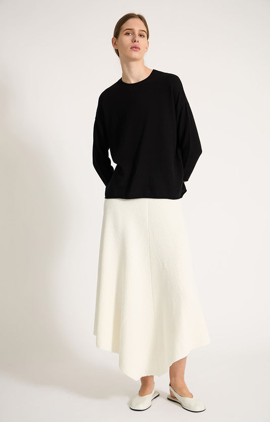 Woman wearing Sabi cotton sweater with dropped shoulders and cropped sleeves in colour Black. 