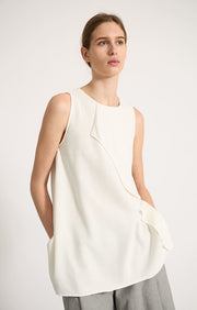 Woman wearing Sinca sleeveless cotton top in colour Ivory.