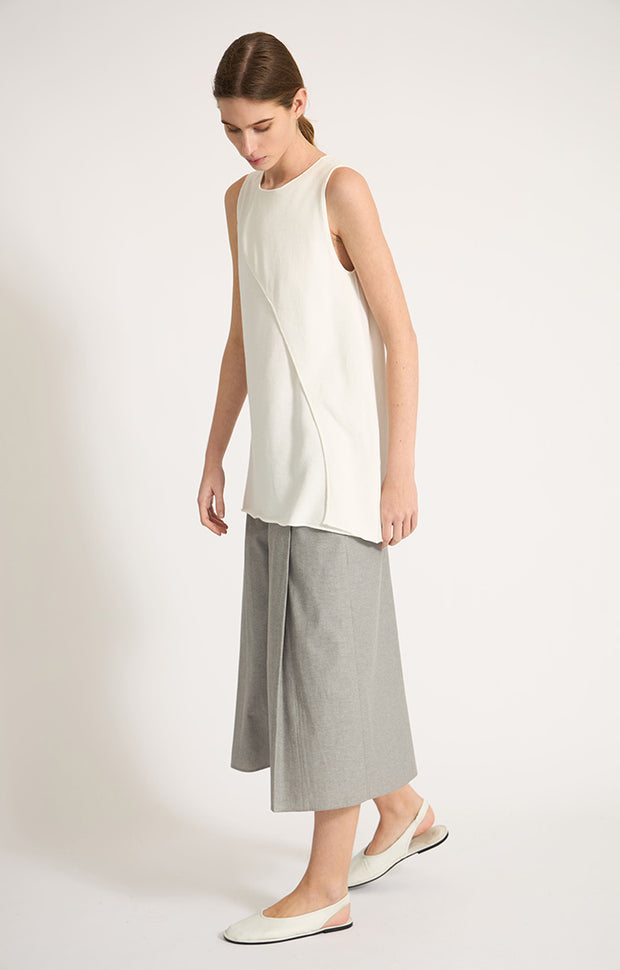 Woman wearing Sinca sleeveless cotton top in colour Ivory.