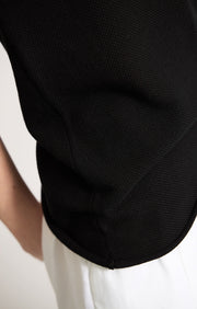 Woman wearing Takai cotton top in colour Black.
