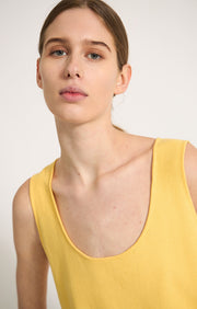 Woman wearing Takai cotton top in colour Lemon. 