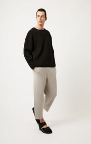 Person wearing Axa oversized fit cashmere sweater with drop shoulders and rounded sleeves in colour Black.